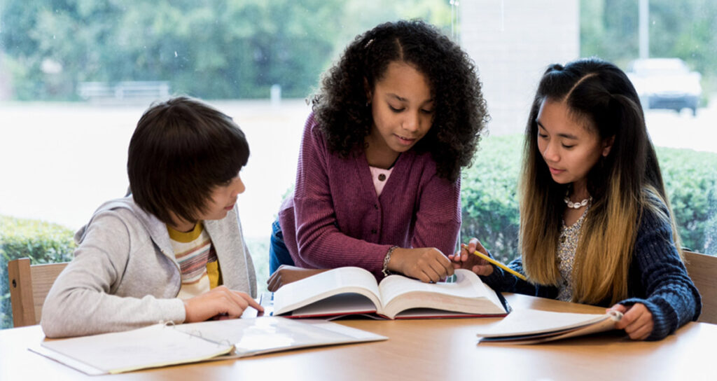Teacher working with middle school students