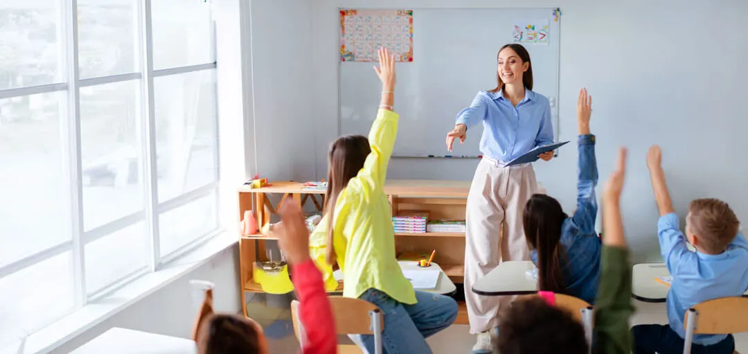 Student raising hand in a classroom