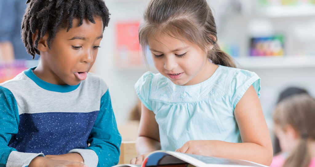 happy students reading exciting book