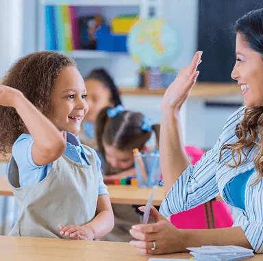 Teacher high fiving a student